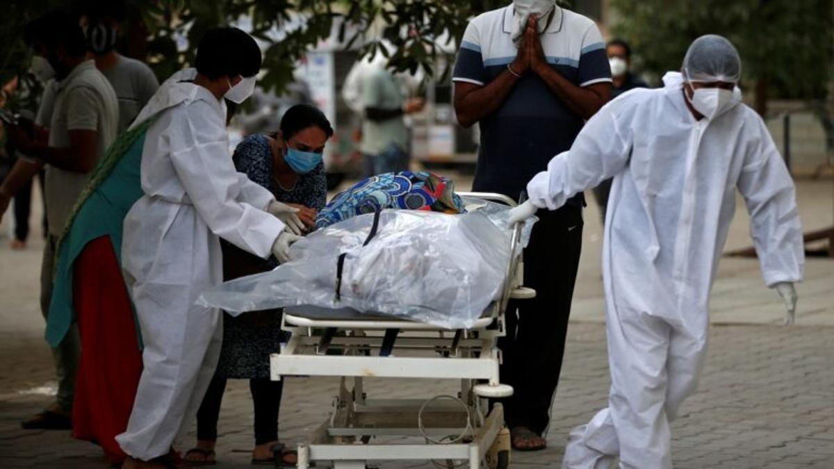 Sanitarios trasladan el cadáver de un fallecido por covid-19 en la India.