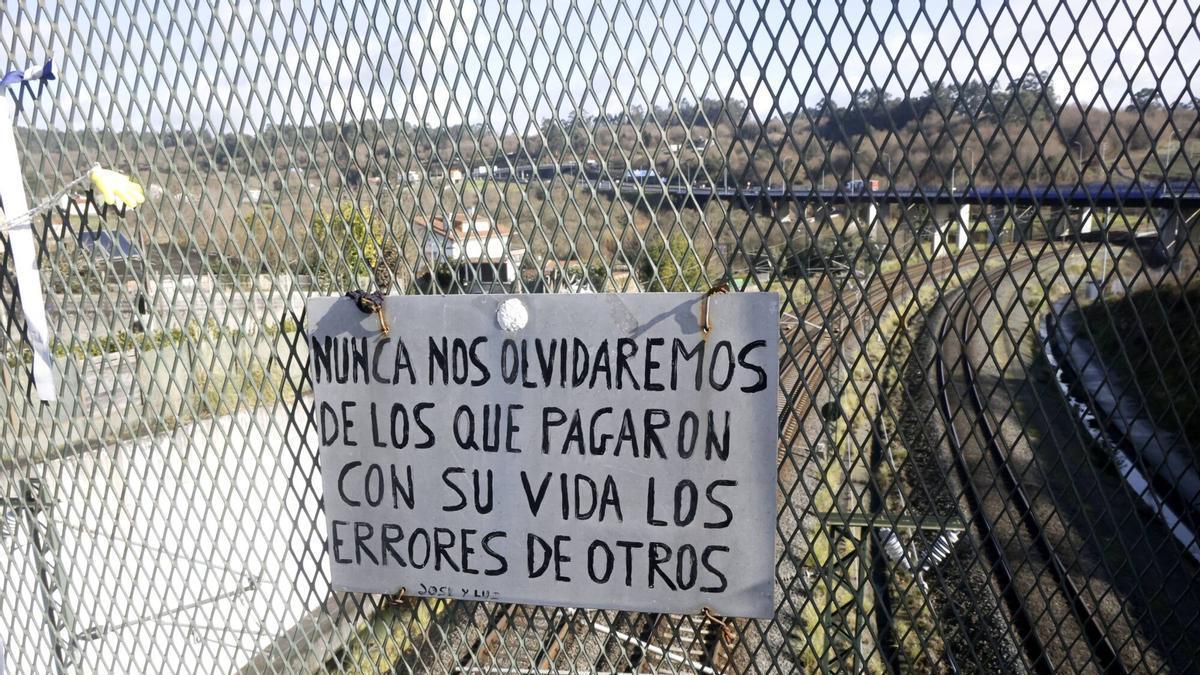 Cartel manuscrito colocado, en el lugar del accidente, en memoria de las víctimas.