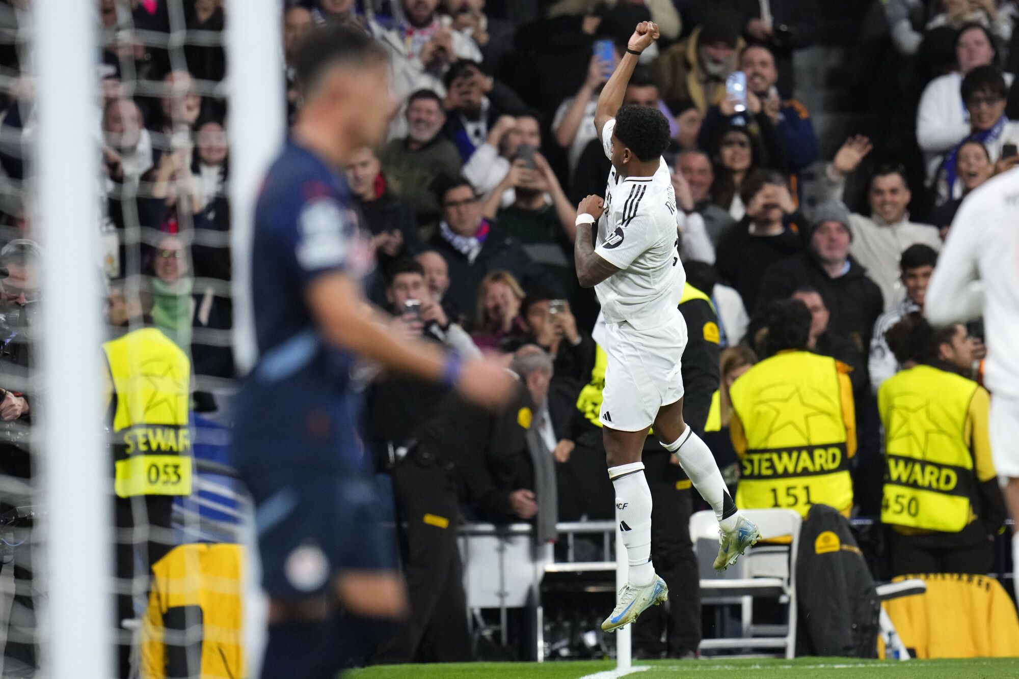 Real Madrid's Rodrygo celebrates after scoring the opening goal during the Champions League opening phase soccer match between Real Madrid and FC Salzburg at the Santiago Bernabeu stadium in Madrid, Wednesday, Jan. 22, 2025. (AP Photo/Manu Fernandez). EDITORIAL USE ONLY/ONLY ITALY AND SPAIN