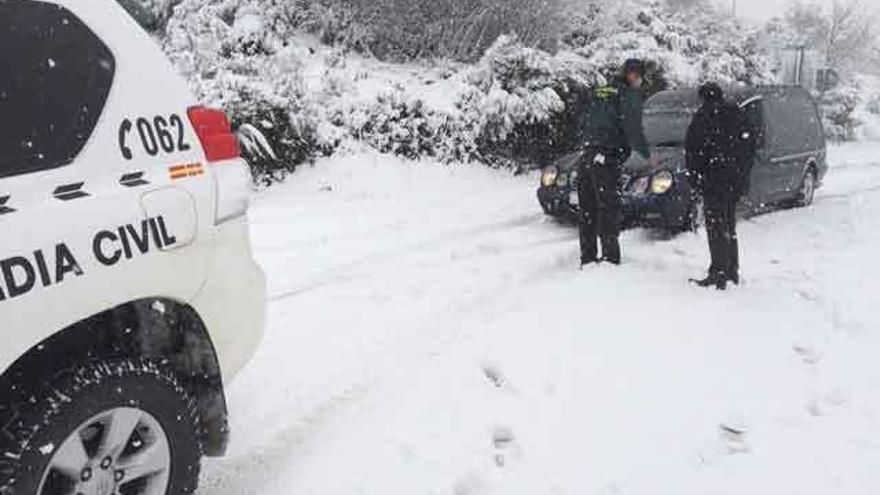Agentes de la Guardia Civil durante el auxilio al conductor de la funeraria en la carretera de Porto.