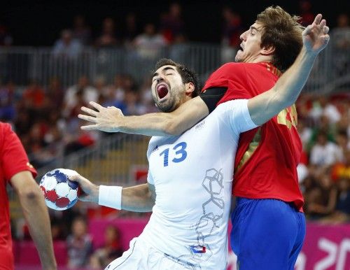 France's Nikola Karabatic is challenged by Spain's Viran Morros de Argila in their men's handball quarterfinals match at the Basketball Arena in London