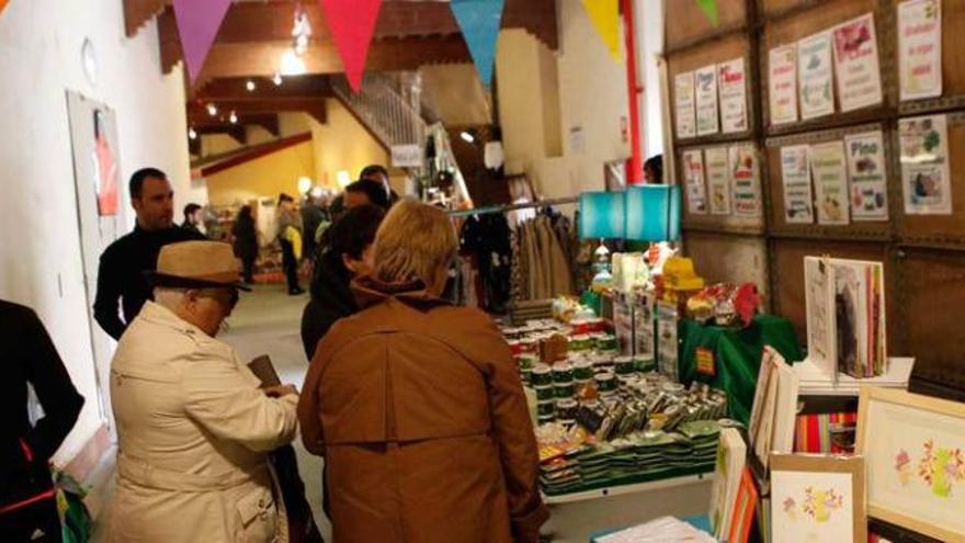 Visitantes, ayer, en el mercadillo montado en la plaza de toros de El Bibio.