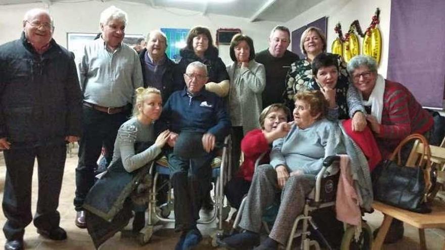 Familiares, amigos y vecinos de Pilar Arjones (en silla de ruedas) celebran su centenario. // D.P.