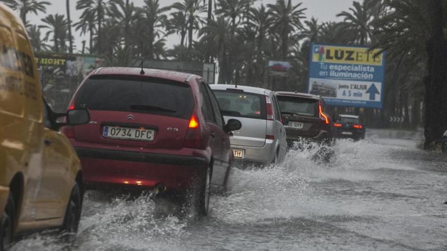 Una imagen de varios coches circulando bajo la fuerte lluvia