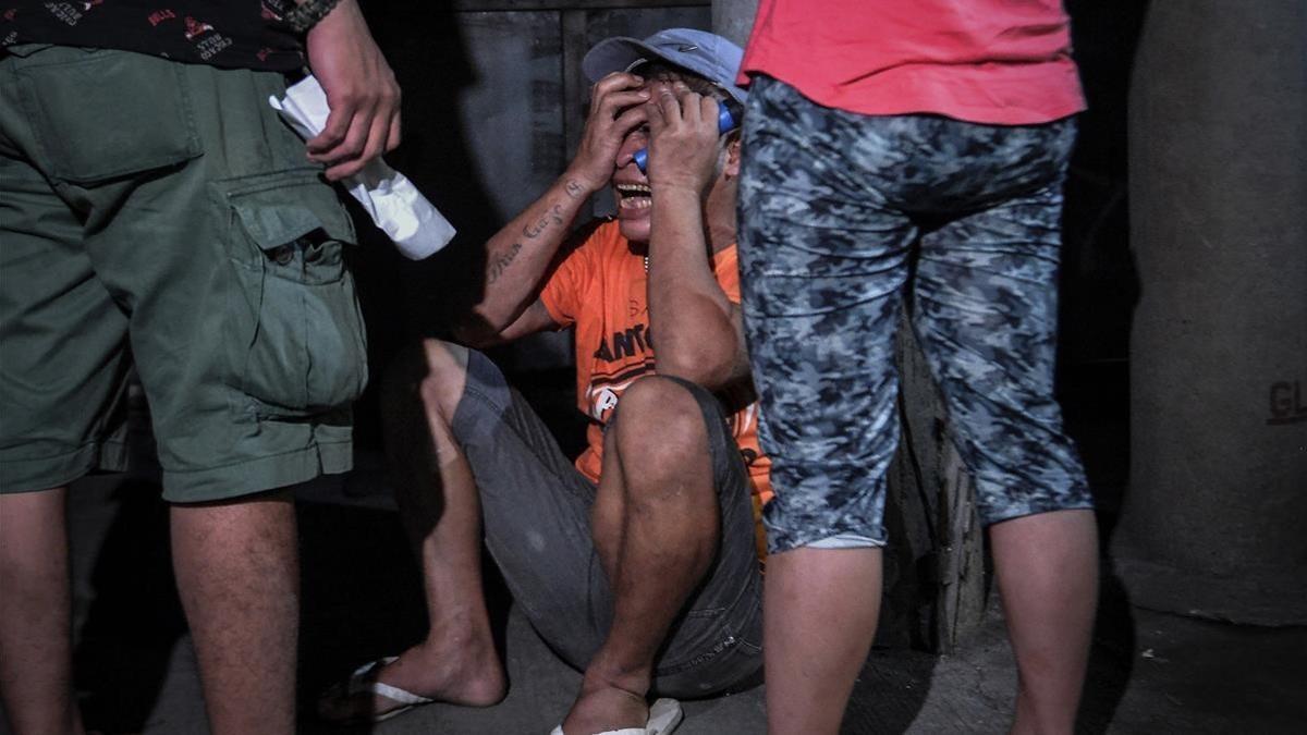 Un familiar llora a una víctima de una operración policial antidroga en Manila, el 17 de agosto