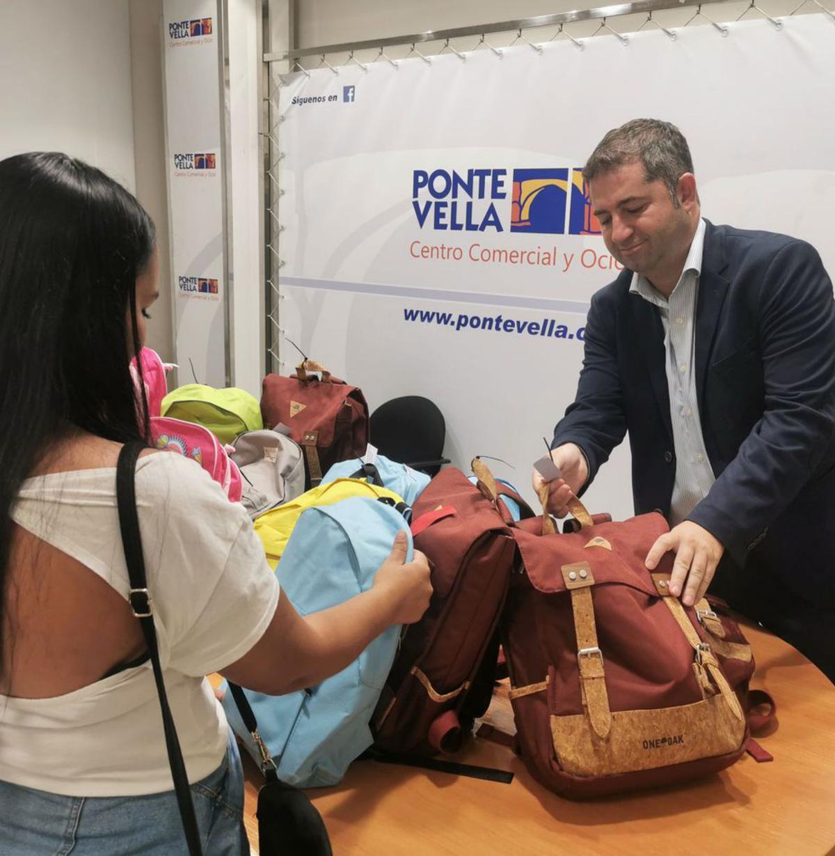 Una madre recibe una mochila en el Pontevella.  |  // I. OSORIO