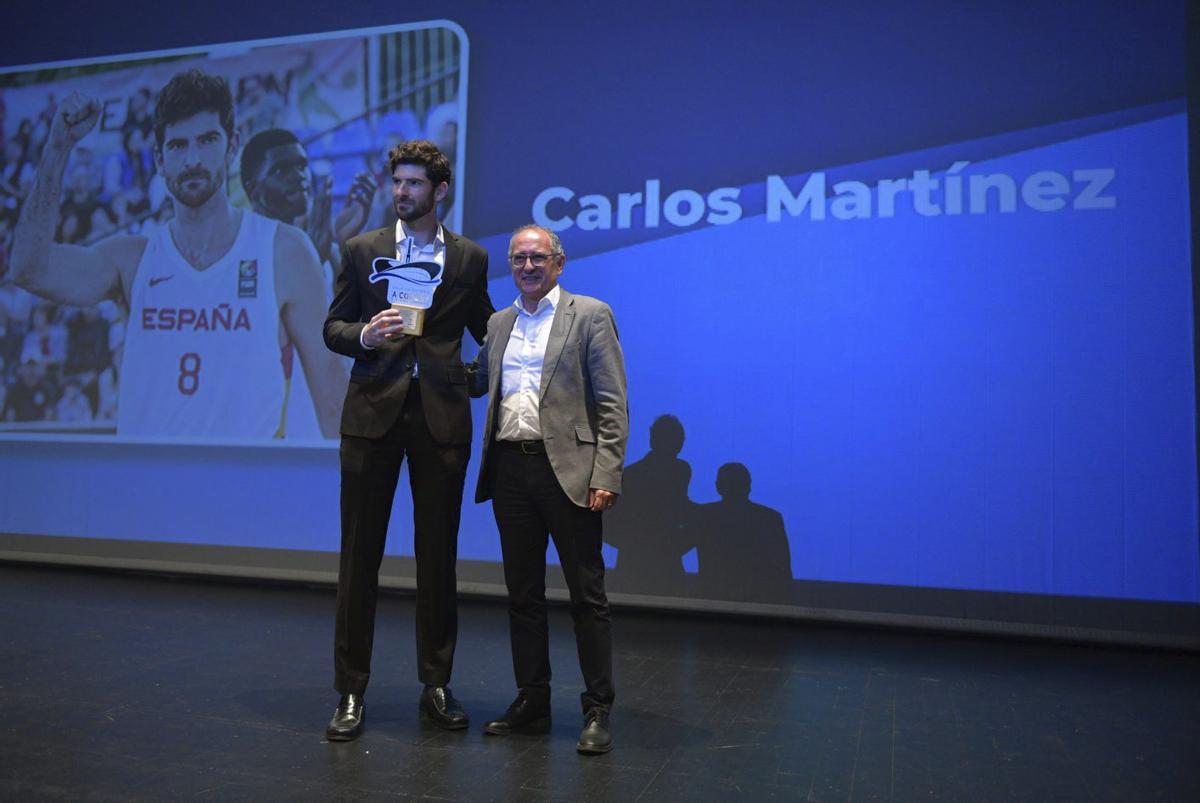 Carlos Martínez recibe el premio de Juan Carlos Da Silva, director general de Prensa Ibérica Galicia. | CARLOS PARDELLAS