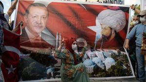 Una mujer posa ante un cartel con la representación del presidente turco, Recep Tayyip Erdogan, y del sultán otomano Mehmet II, ayer en Estambul.
