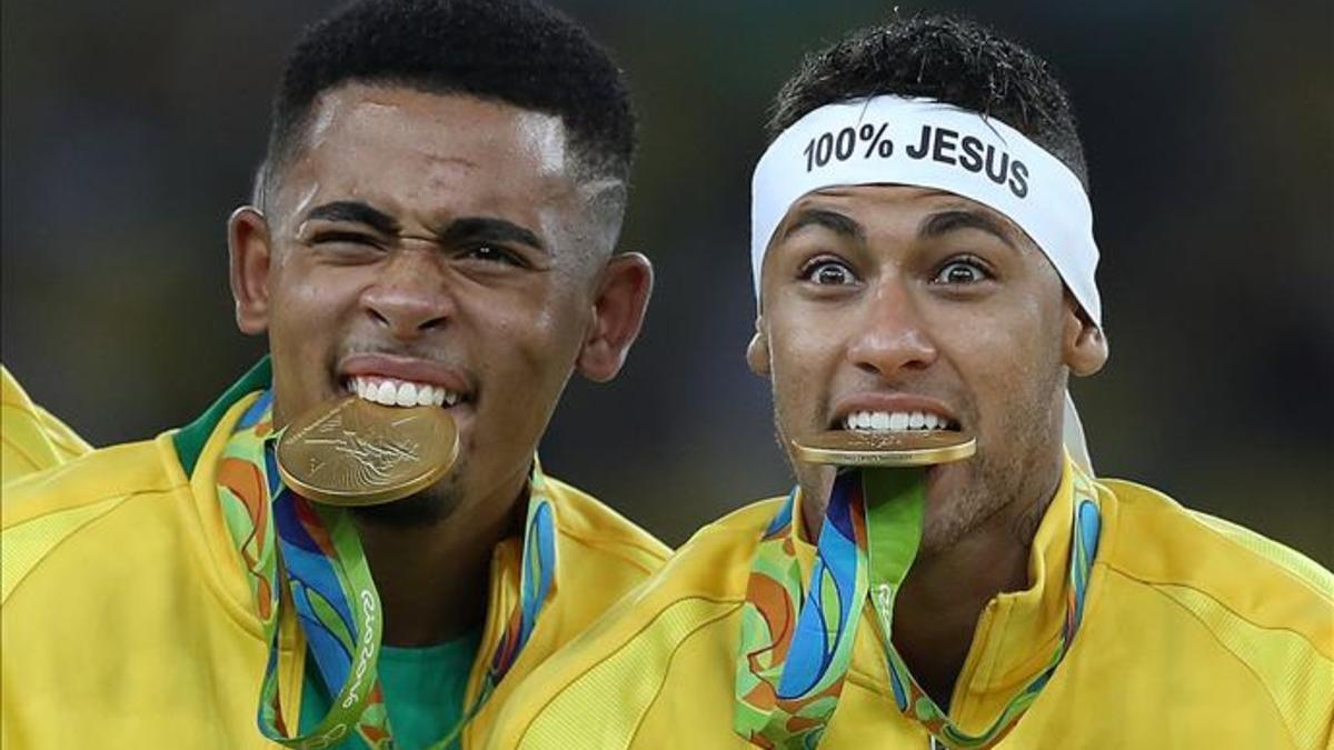 Gabriel Jesús y Neymar con sus medallas de oro entre sus dientes
