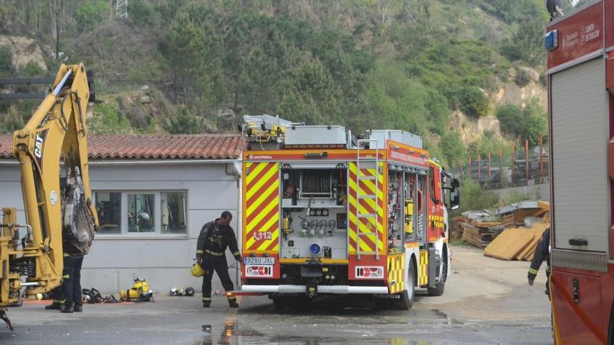 Operarios de Emergencias trabajando en la zona de la nave quemada en Caldas.