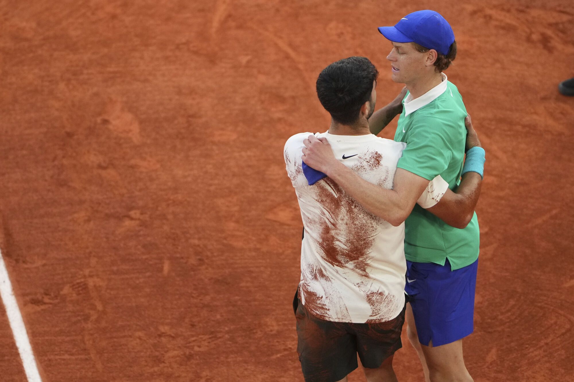 Winner Spain's Carlos Alcaraz, left, and Italy's Jannik Sinner hug after their final match of the French Tennis Open at the Roland-Garros stadium in Paris, Sunday, June 8, 2025. (AP Photo/Lindsey Wasson)