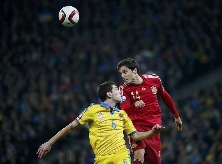 Ukraine's Stepanenko goes for a header with Spain's Etxeita during their Euro 2016 group C qualifying soccer match at the Olympic stadium in Kiev