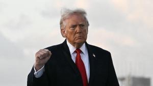 El presidente estadounidense Donald Trump levanta el puño a su llegada al Aeropuerto Internacional de Miami, el 11 de abril de 2026.