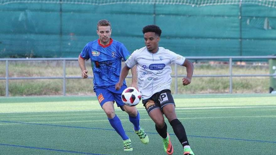 Raly Cabral, del Ourense CF, controla un balón presionado por Toño, del Barbadás, ayer en Oira. // I. O.