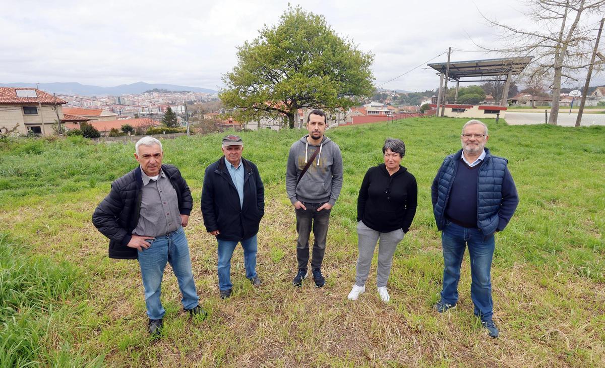 Representantes de la entidad vecinal en los terrenos en los que está proyectada la construcción del pabellón.