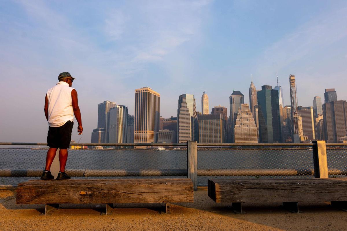 NEW YORK, NEW YORK - JULY 17: Haze from Canadian wildfires blankets the Manhattan skyline as seen from Brooklyn Bridge Park on July 17, 2026 in New York City. New York City has been under an Air Quality Health Advisory as the Canadian and Great Lakes wildfire smoke gradually moves through the area, creating a thick haze in the heat. Spencer Platt/Getty Images/AFP (Photo by SPENCER PLATT / GETTY IMAGES NORTH AMERICA / Getty Images via AFP)