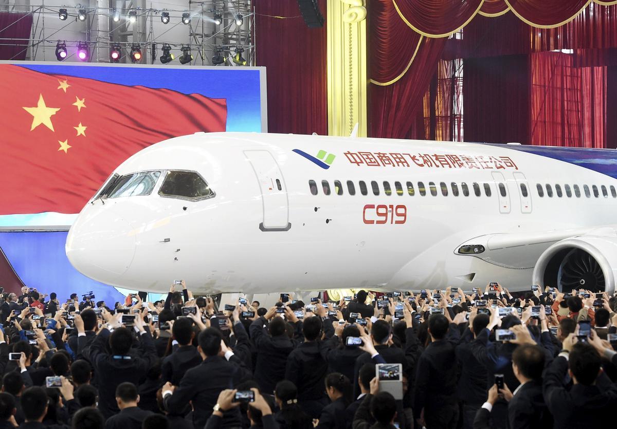 The first C919 passenger jet made by the Commercial Aircraft Corp of China (Comac) is pulled out during a news conference at the