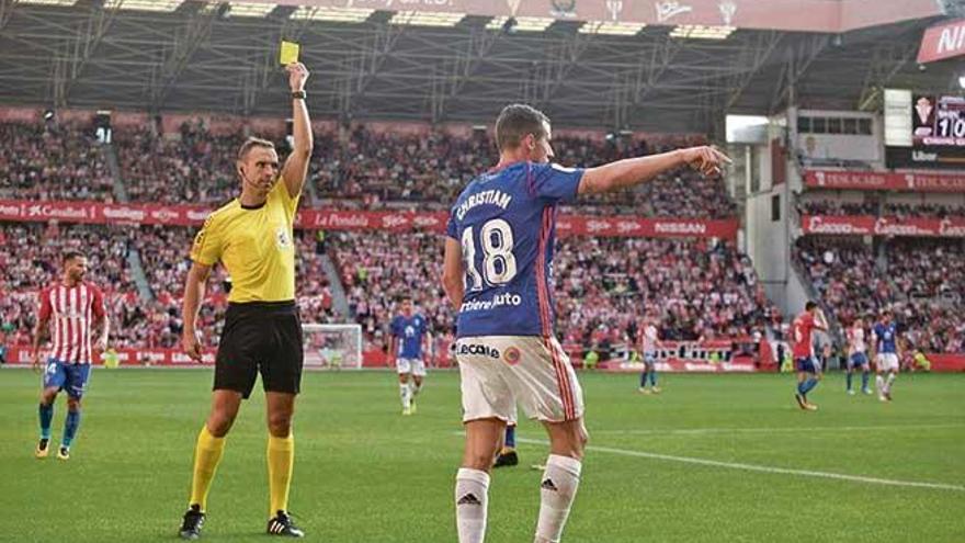 Guillermo Cuadra enseña una tarjeta en el Sporting-Oviedo de esta temporada.