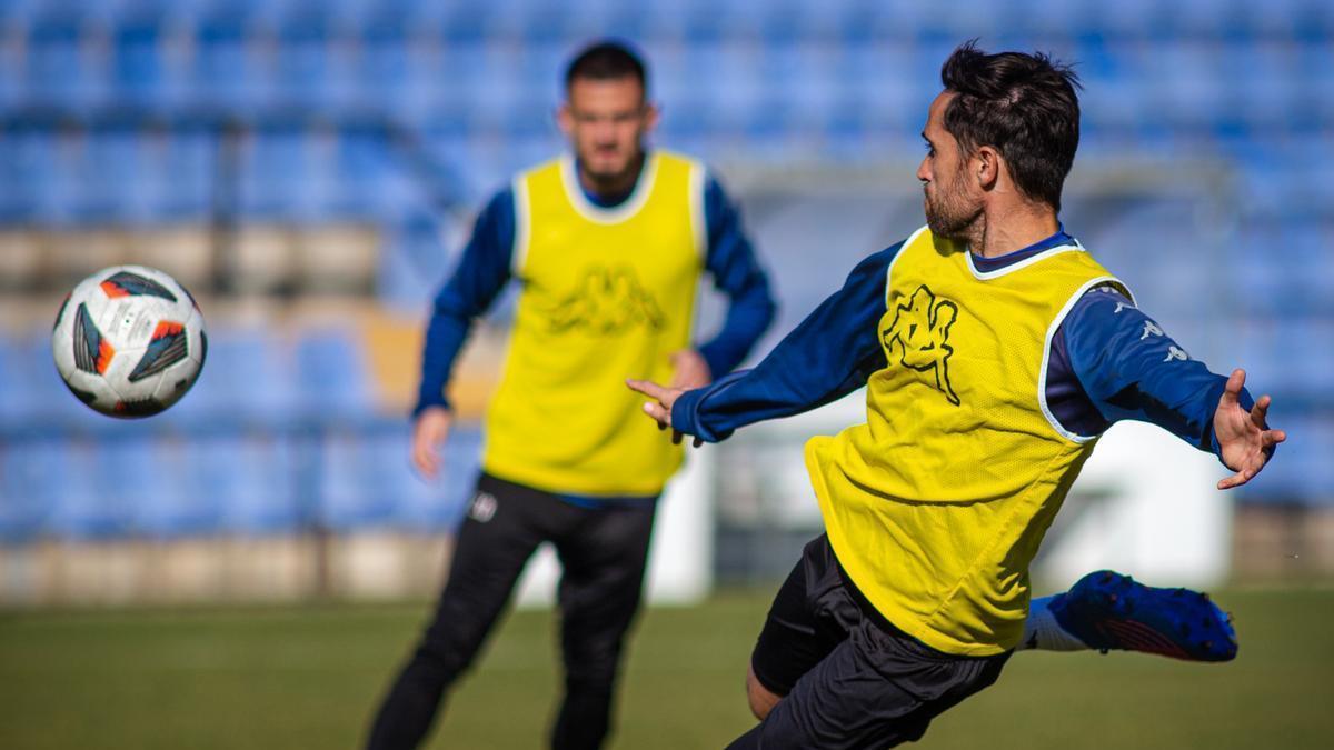 Míchel Herrero, con Artiles al fondo, prueba el golpeo en una sesión de trabajo con pelota.