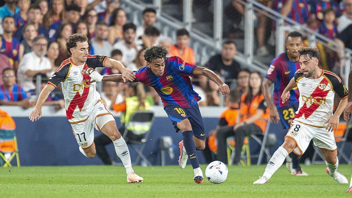 Lamine se intenta escapar de la defensa del Rayo, este lunes en el Camp Nou.