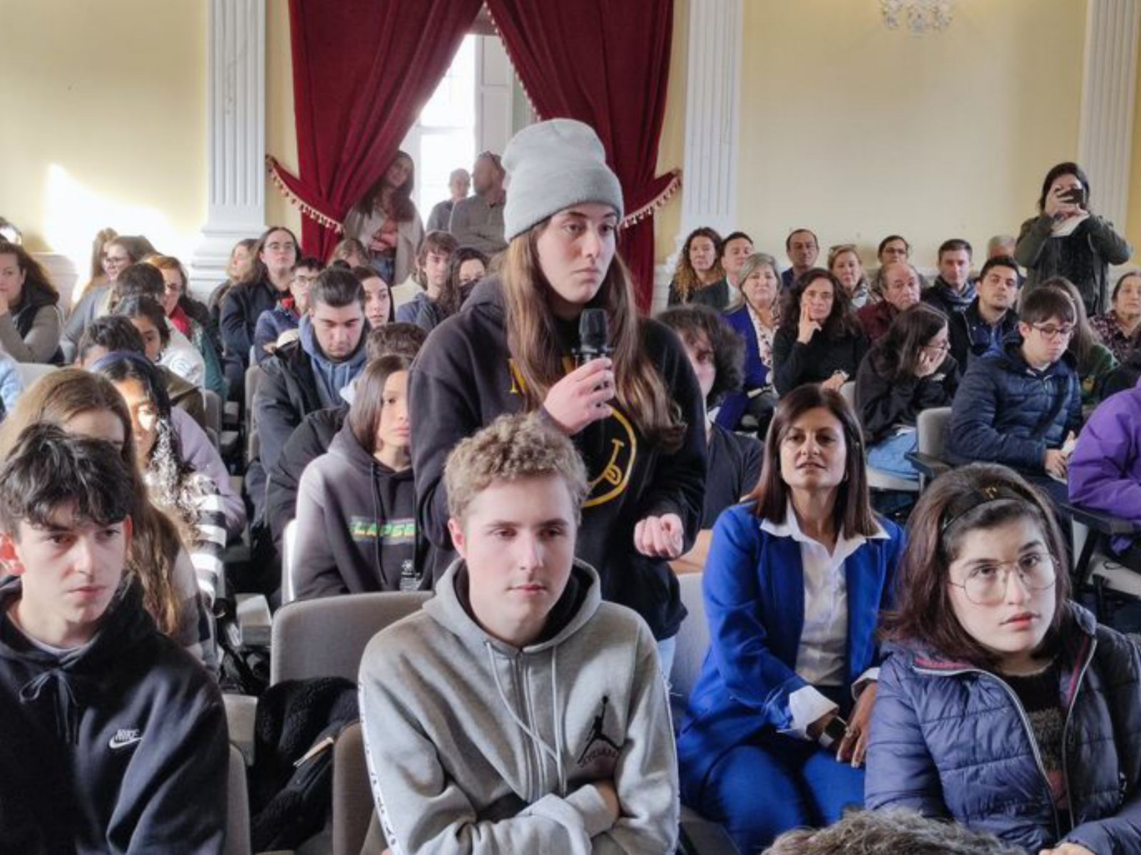 Una alumna formula una pregunta durante el coloquio.