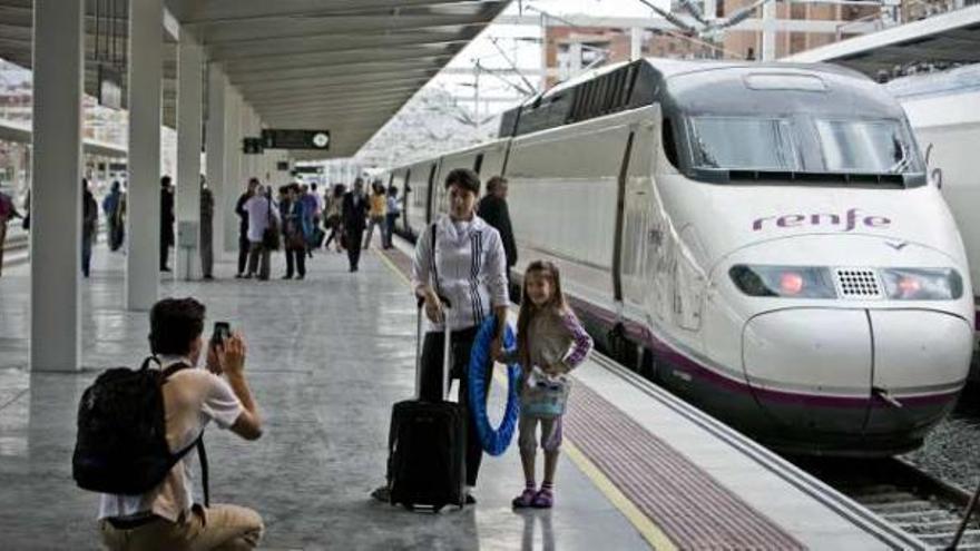 Un familia se fotografía junto a un AVE en Alicante.