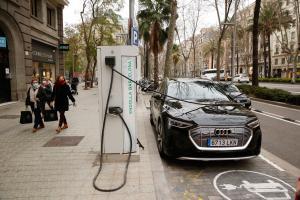 Un coche eléctrico se carga en un poste de recarga en Barcelona.