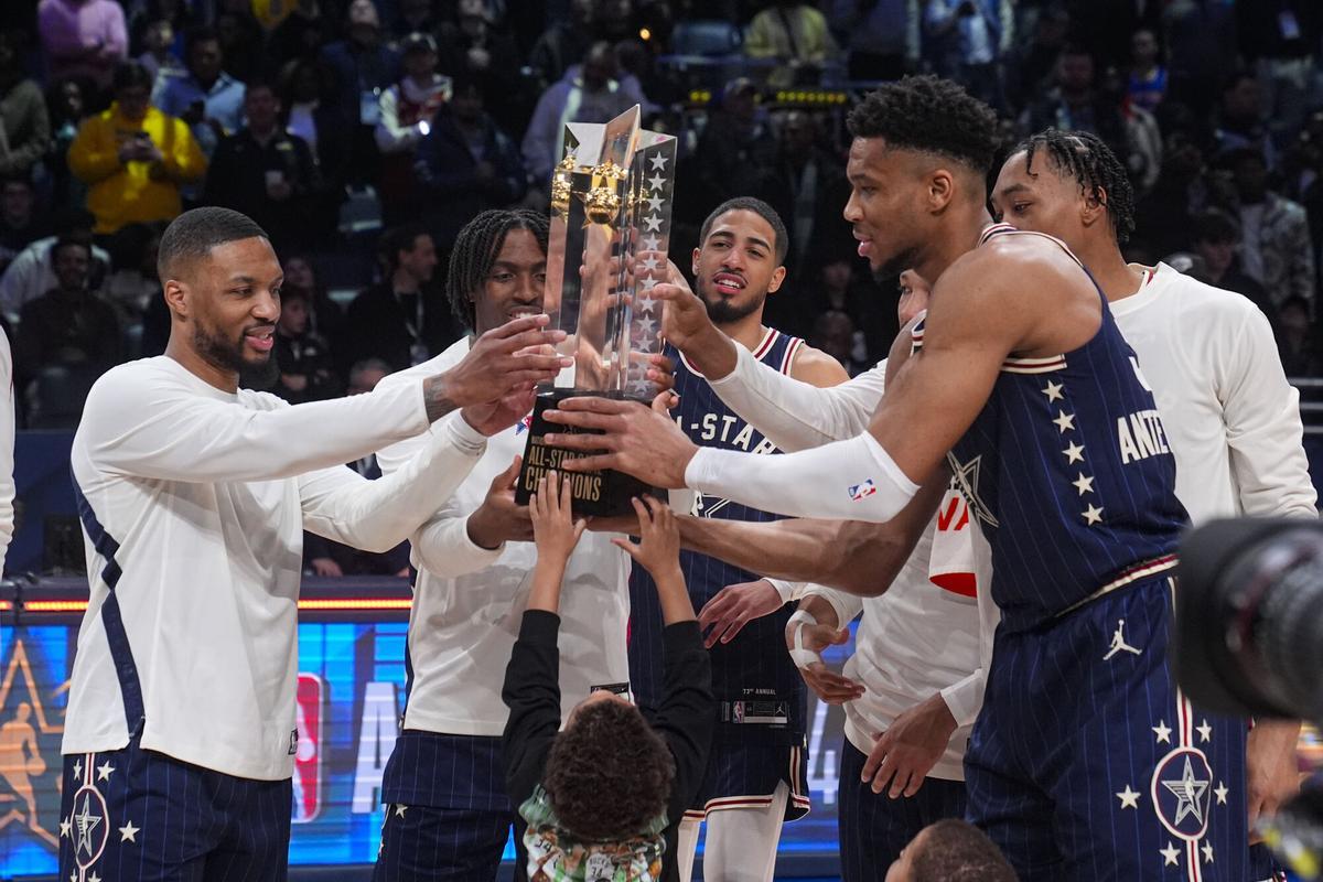 FILE - The East team, lead by captain Milwaukee Bucks forward Giannis Antetokounmpo, right, hoists the trophy after defeating the West 211-186 in the NBA All-Star basketball game in Indianapolis, Sunday, Feb. 18, 2024. (AP Photo/Darron Cummings, File). FILE PHOTO