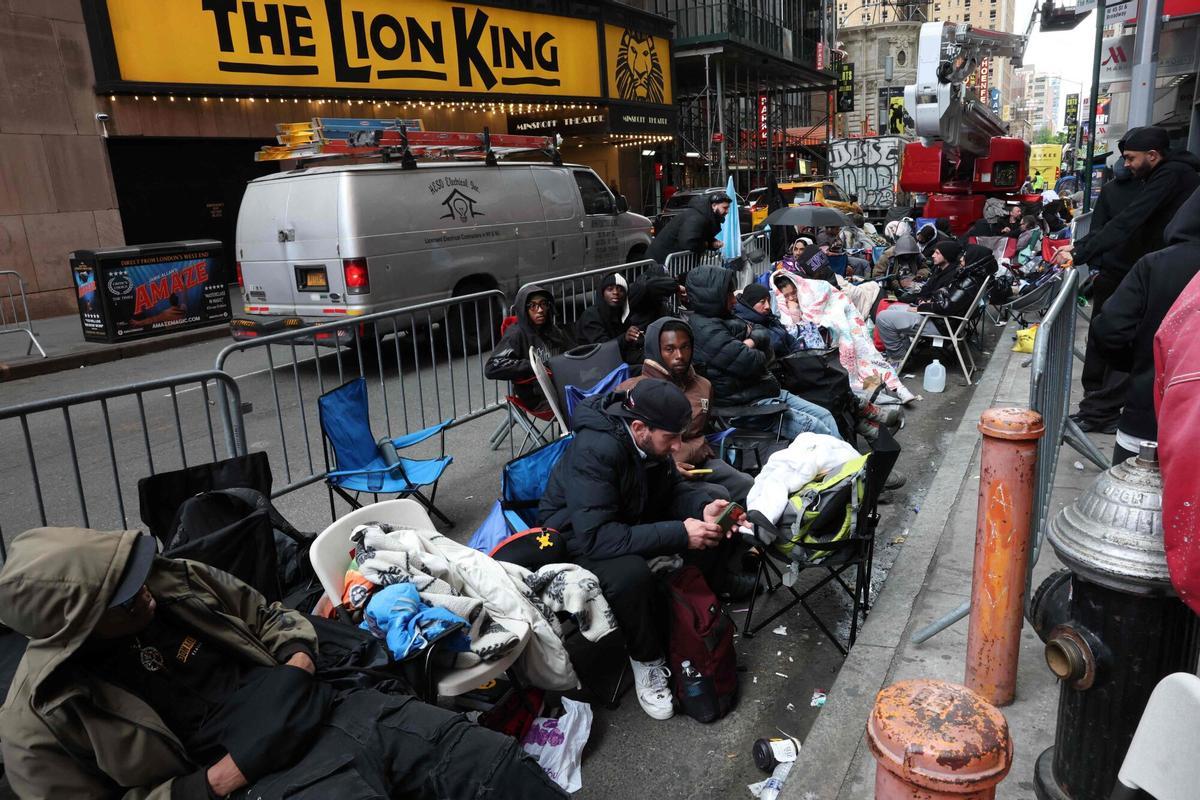This photo taken on May 15, 2026, shows people camping out in line outside of the Swatch store in Times Square in New York, ahead of the May 16 release of the Audemars Piguet x Swatch Royal Pop watch. The collaboration between two Swiss watch brands, Swatch and Audemars Piguet, was highly anticipated by fans with some clients waiting for days ahead of the release. (Photo by TIMOTHY A. CLARY / AFP)