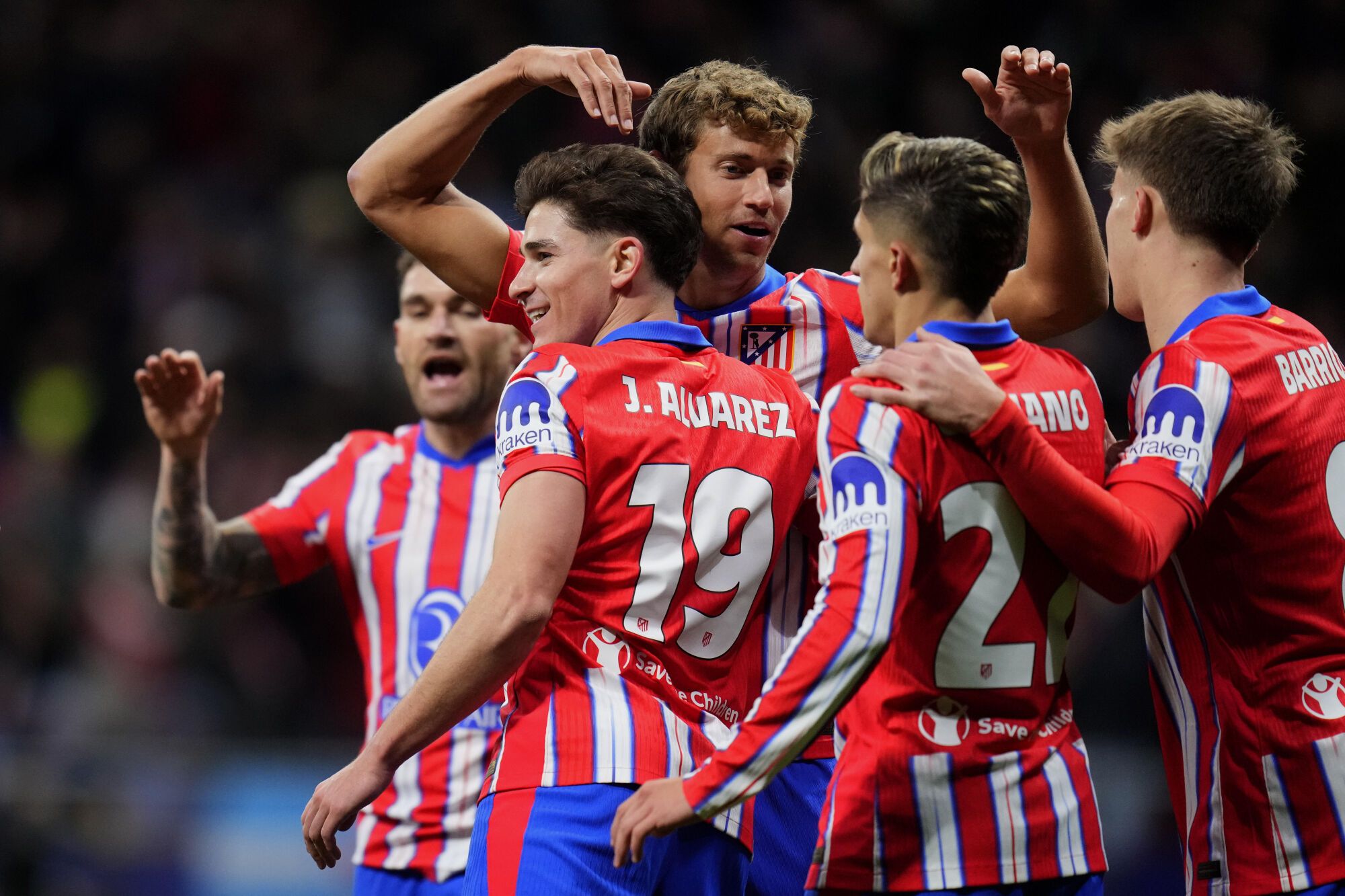 Atletico Madrid's Julian Alvarez (19) celebrates with teammates after scoring the opening goal during the Champions League opening phase soccer match between Atletico Madrid and Slovan Bratislava at Riyadh Air Metropolitano stadium in Madrid, Spain, Wednesday, Dec. 11, 2024. (AP Photo/Manu Fernandez). EDITORIAL USE ONLY/ONLY ITALY AND SPAIN