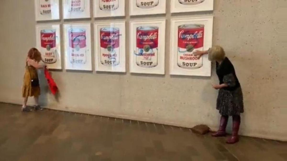 Dos activistas se pegan a las Latas de sopa Campbell de Warhol en Australia