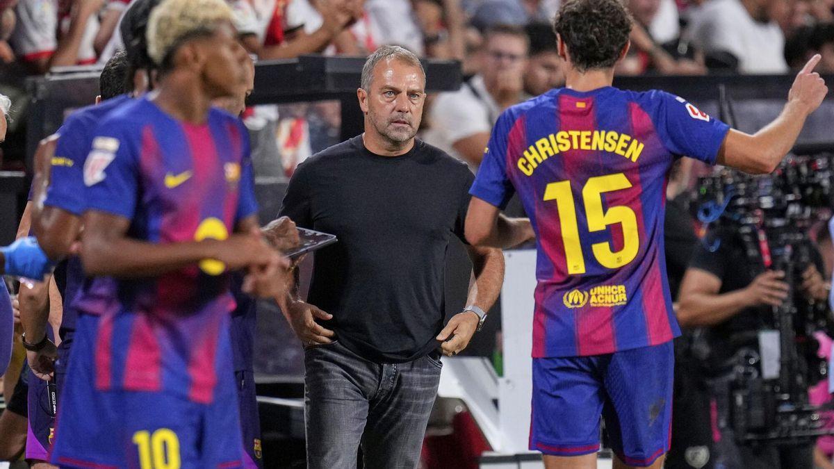 Barcelona's head coach Hansi Flick speaks to Andreas Christensen during the Spanish La Liga soccer match between Rayo Vallecano and FC Barcelona at the Vallecas stadium in Madrid, Spain, Sunday, Aug. 31, 2025. (AP Photo/Manu Fernandez)
