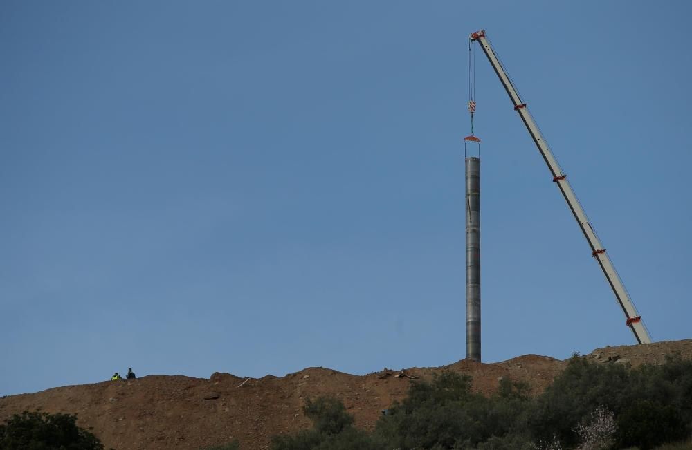 A crane removes steel tubes after failing to ...