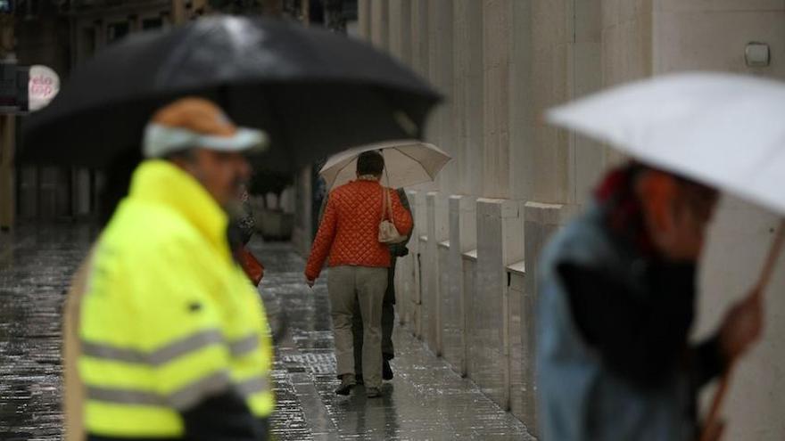 La lluvia ha obligado a sacar el paraguas en la capital.