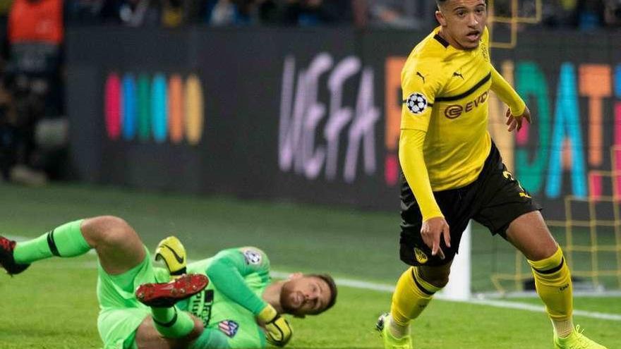 Sancho celebra el tercer gol del Dortmund, con Oblak tirado sobre el césped.