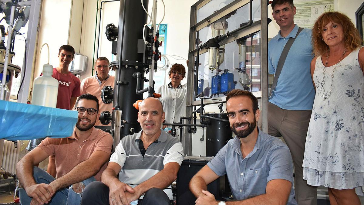 Una representació de l’equip: d’esquerra a dreta, drets, Joan Morell, Toni Escobet, Conxita Lao, Albert Martínez i Montse Solé; asseguts,  Marc Bascompta, Lluís Sanmiquel i Toni Dorado, al costat de la planta que han construït per fer el procés d’extracció dels metalls  | G.C.