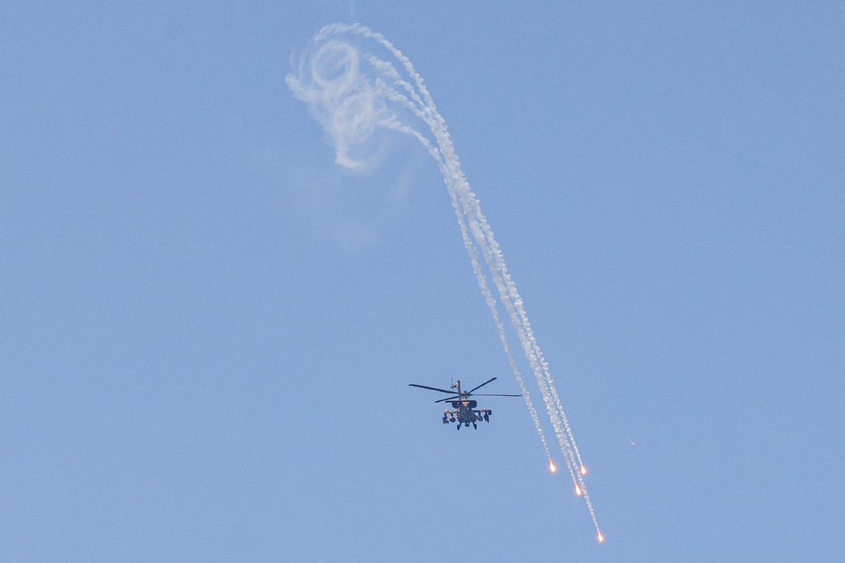Un helicóptero de ataque Apache AH-64 del ejército israelí dispara bengalas mientras sobrevuela Ashkelon, en el sur de Israel