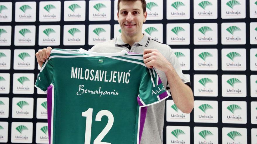 El jugador cajista posa con su camiseta, con una sonrisa.