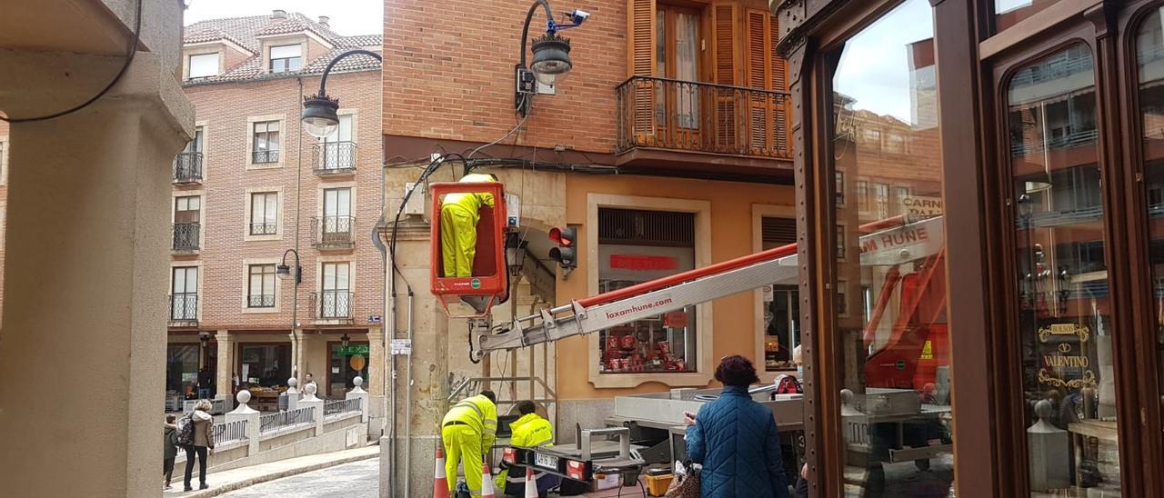 Operarios instalando la cámara de vídeo vigilancia en la calle la Rúa.