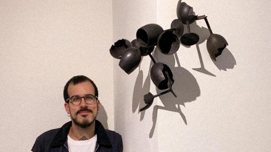 Daniel de la Guardia junto a una escultura de pared que expone en Bronzo.