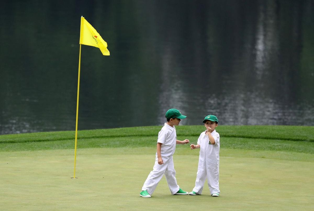 AUGUSTA, GA - APRIL 05: Two children stand on a green during the Par 3 Contest prior to the start of the 2017 Masters Tournament at Augusta National Golf Club on April 5, 2017 in Augusta, Georgia. The Par 3 Contest was later cancelled due to inclement weather.   Rob Carr/Getty Images/AFP