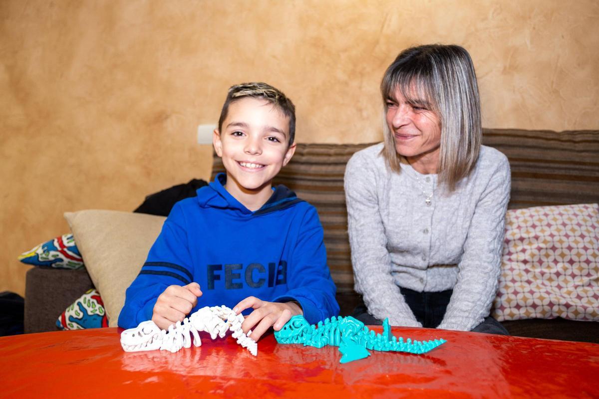 José Luis juega en el salón de su casa junto a la atenta mirada de su madre, María José.