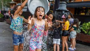 Un grupo de niñas se refrescan durante la ola de calor en una plaza de Sant Celoni, pueblo de 18.000 habitantes sin piscina municipal. 