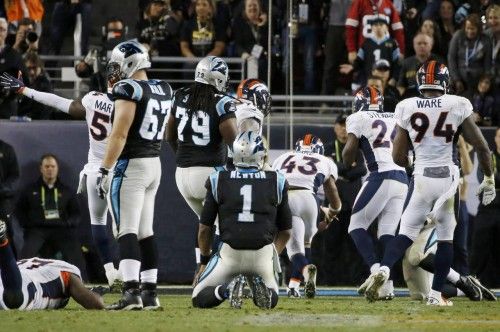 Carolina Panthers' quarterback Newton watches as Denver Broncos' Ward recovers his fumble in the fourth quarter of the NFL's Super Bowl 50 football game in Santa Clara