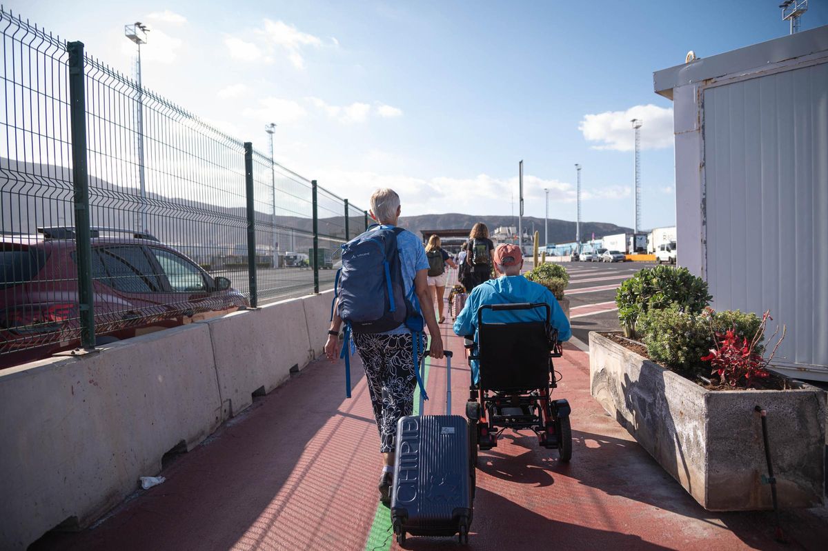 Turistas se dirigen a la zona de embarque del Puerto de Los Cristianos.