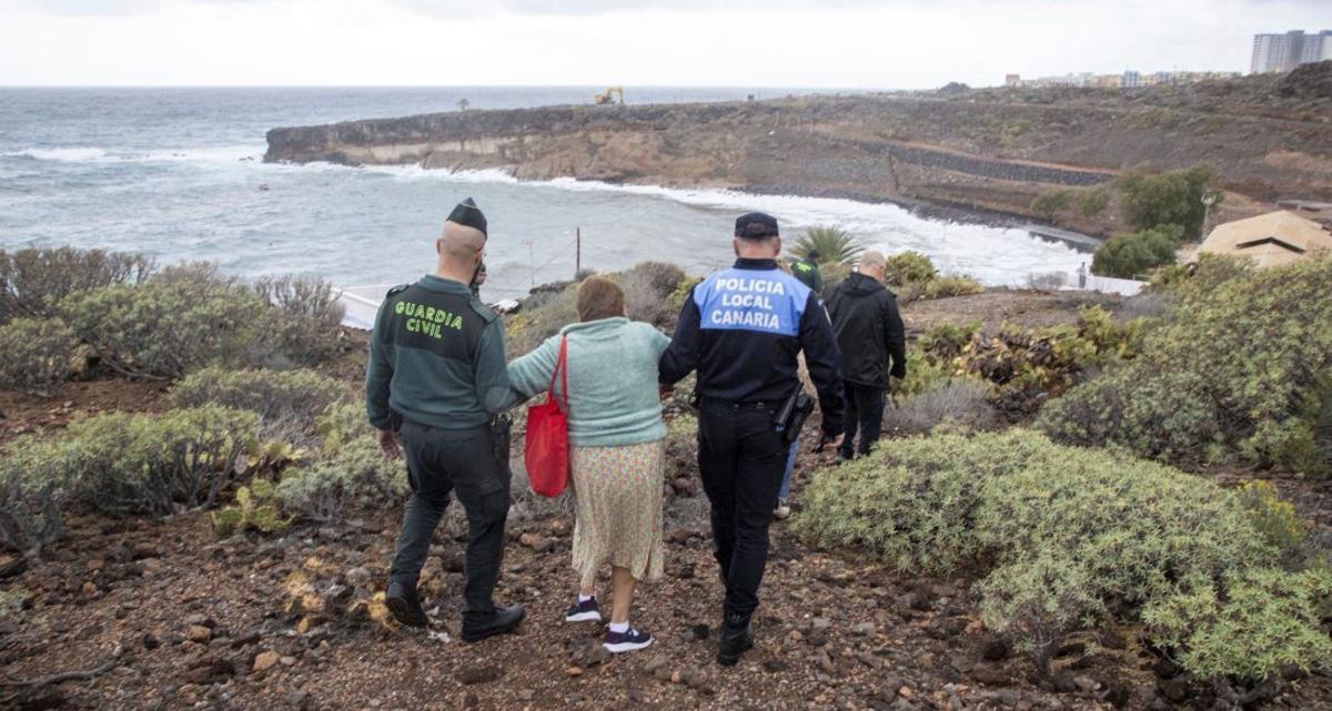 Un guardia civil y un policía local de Adeje acompañan a una mujer desalojada de su casa. | E. D.