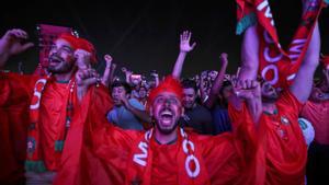 Aficionados marroquíes celebran en Doha la clasificación de su equipo a cuartos del Mundial de Qatar tras derrotar a España. 