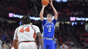 Duke guard/forward Cooper Flagg (2) shoots over Syracuse center Eddie Lampkin Jr. (44) during the first half of an NCAA college basketball game in Syracuse, N.Y., Wednesday, Feb. 5, 2025. (AP Photo/Adrian Kraus)