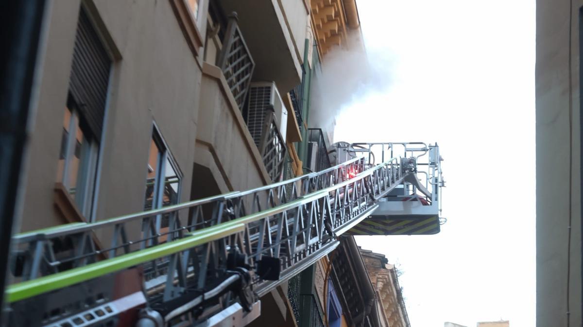 Los bomberos luchan con las llamas desde una autoescala.