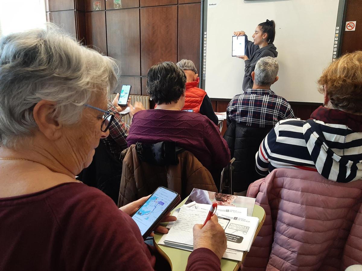 Una mujer toma notas en una libreta sobre las explicaciones de la monitora.